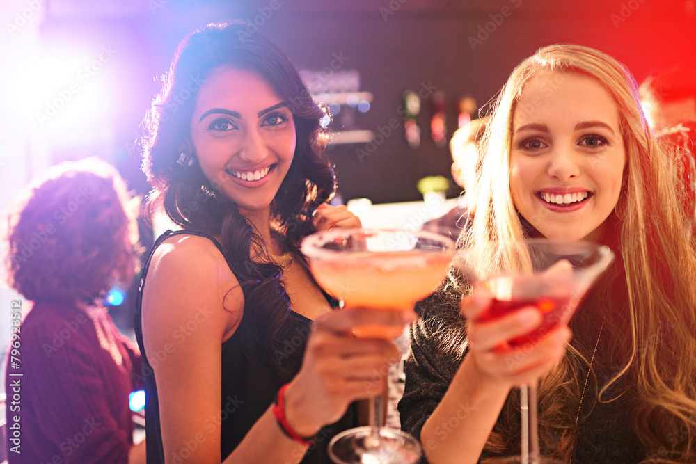 Girl, friends and cocktail with portrait with toast in nightclub, congratulations and happy hour. Women, club and drink with margarita, alcohol and smile at event in new year with cheers in night