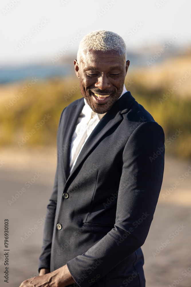 Elegant African American man posing on the beach Elegant African American man posing on the beach