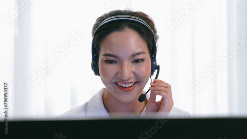 Businesswoman wearing vivancy headset working in office to support remote customer or colleague. Call center, telemarketing, customer support agent provide service on telephone video conference call
