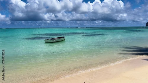A boat, cockleboat  in turquoise crystal waters on a tropical island. pereybere beach, mauritius (ID: 796958126)