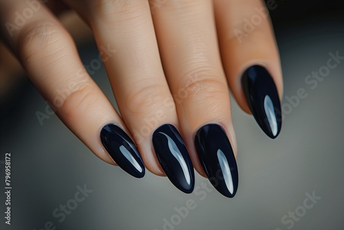 Glamour woman hand with navy blue nail polish on her fingernails. Nail art and design. Female hand model. French manicure.