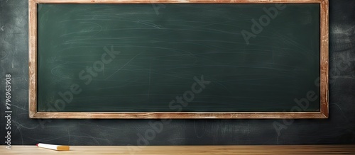 Wooden table featuring chalkboard and chalk stick photo