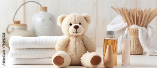 A bottle beside a plush bear photo