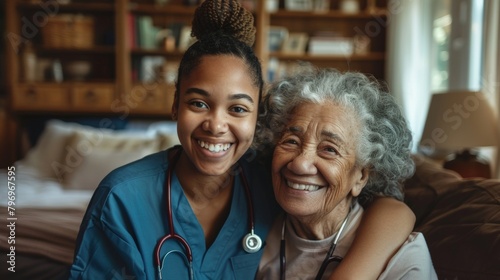 Smiling young female caregiver with a happy elderly patient at home