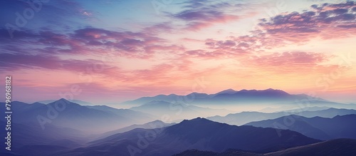 Mountains with a pink sunset and wispy clouds