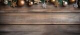 Christmas ornaments on wooden backdrop with room for text