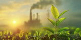 Fresh green leaf in sunlight with an industrial plant in the background