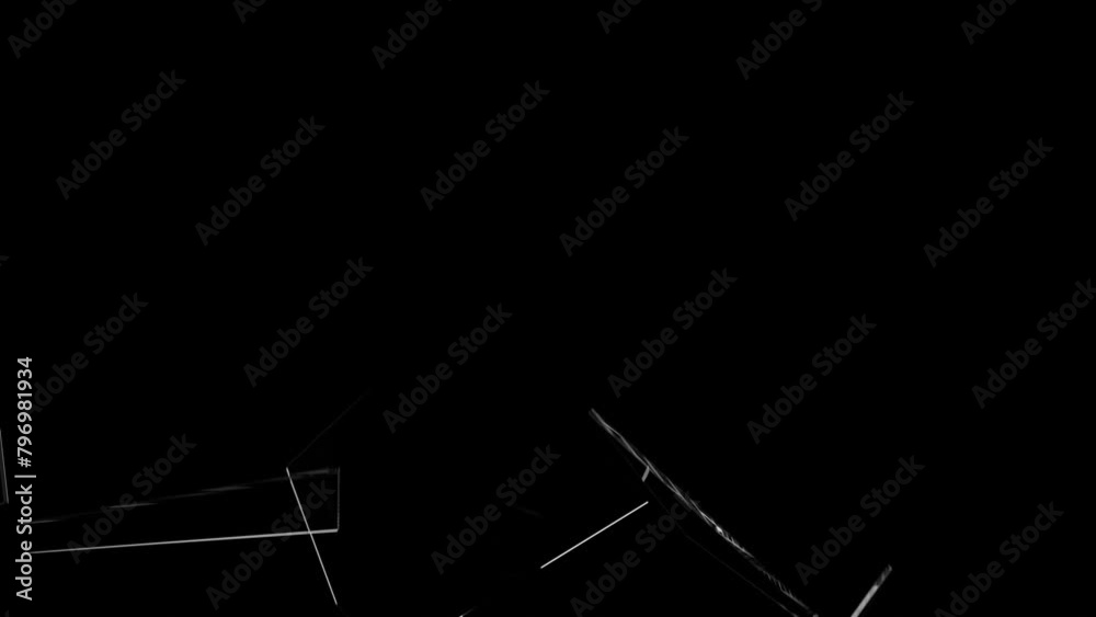 Broken glass on a black background. Glass breaking. Broken glass shard. Flying glass shards.