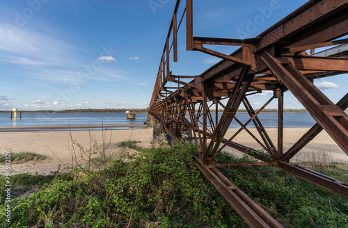Historic steel bridge on the beach of the river Elbe.

