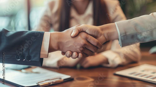 Young Couple Shaking Hands With Real Estate Agent, Signing Contract For Property Investment Or Business Agreement