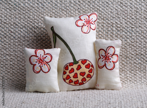 Cushions with cherry and flowers on the sofa photo
