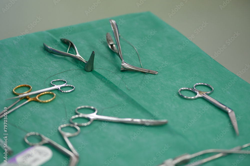 Surgical instruments for otolaryngological operations and septoplasty and rhinoplasty in the operating room. scissors, forceps, raspator, nasal speculum, suture material on the instrument table. Surgical instruments for otolaryngological operations and septoplasty and rhinoplasty in the operating room. scissors, forceps, raspator, nasal speculum, suture material on the instrument table.