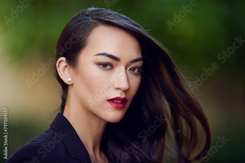 Woman, beauty and lipstick with hair care in portrait, confidence and pride with makeup, elegance and shine. Glamour, style and cosmetics, assertive and feminine with edgy look and elegant outdoor