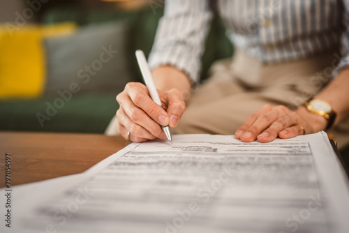 Close up of hand unknown woman sign document work from home