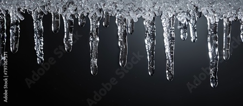 icicles dangle formed by frozen water dripping and freezing in the winter cold. photo