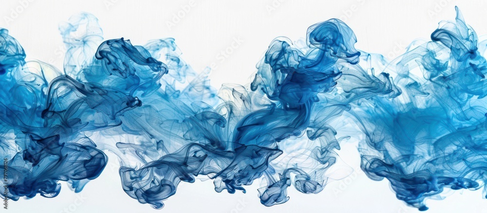 Fototapeta premium Blue Ink Mixing in Water on White Background