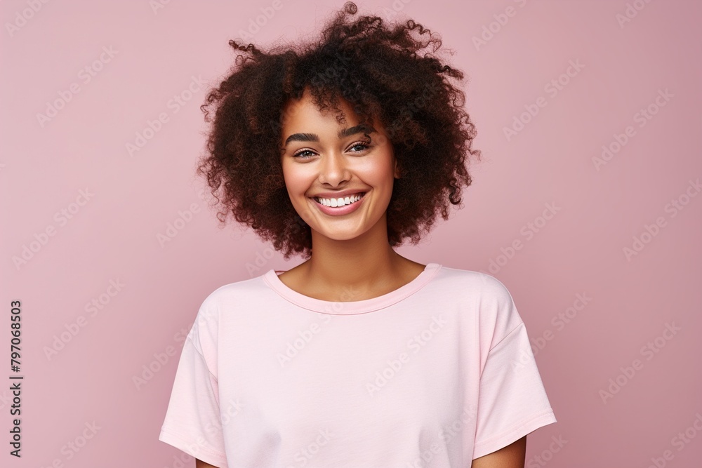 A woman with curly hair is smiling and wearing a pink shirt A woman with curly hair is smiling and wearing a pink shirt