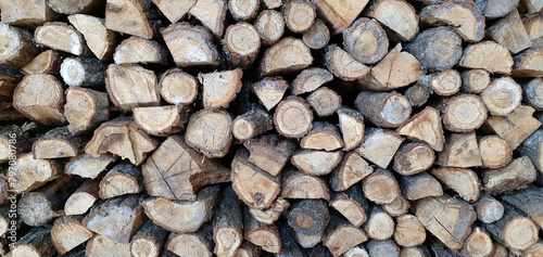 a lot of firewood stacked against the wall  wooden texture background