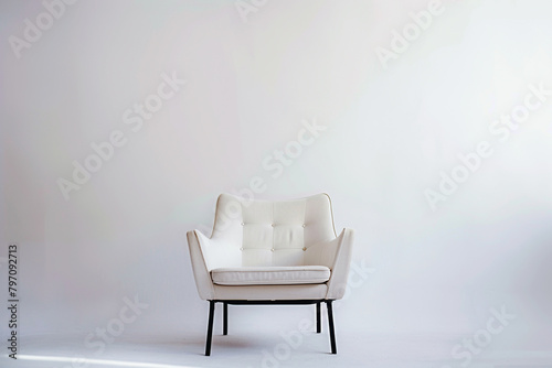 An armchair with a sleek metal frame, showcased on a solid white backdrop.