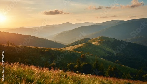 carpathian mountain range in summer at sunset landscape with forested hills and grassy meadows rolling down in to the valley in evening light travel ukraine