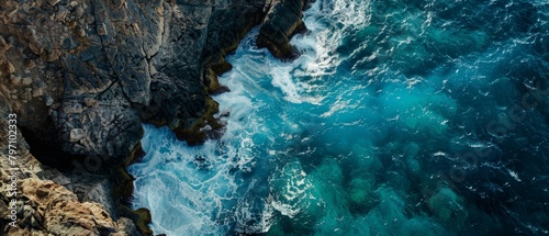 Aerial View of Waves Crashing Against Rocky Cliffs