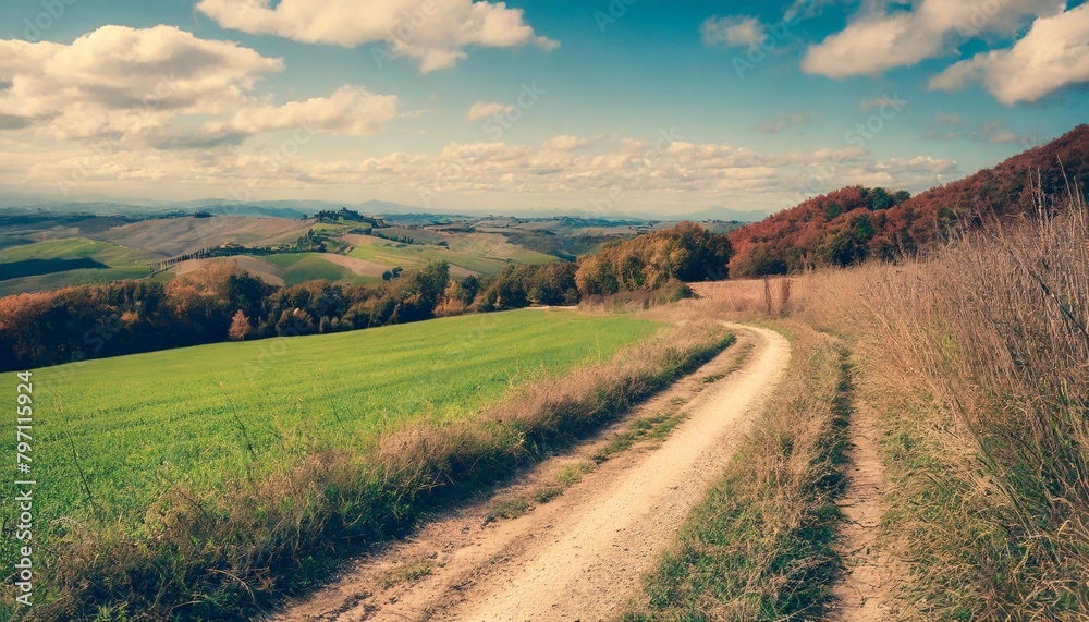 autumn italian rural landscape in retro style panorama of autumn field with dirt road and cloudy sky
