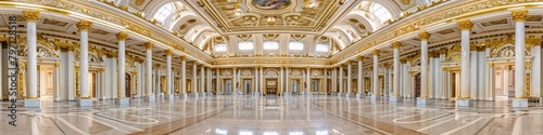 Panoramic view of a grand interior featuring ornate gold decorations, columns, and a detailed ceiling in Art Deco and Neoclassical styles.