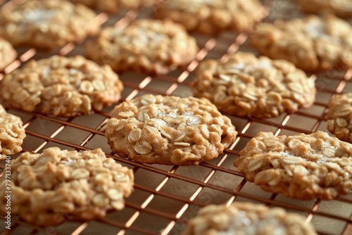 Freshly baked oatmeal cookies cooling on a wire rack photo