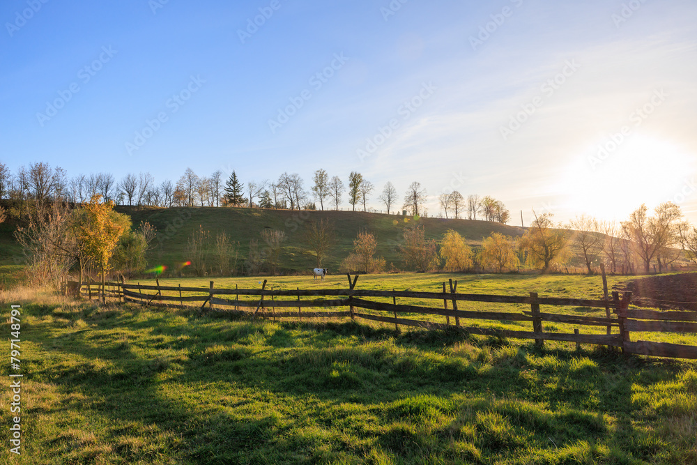 A large, open field with a fence in the middle