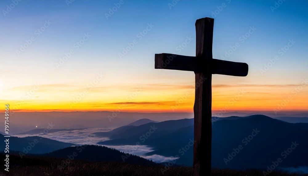 silhouette wooden cross on mountain sunset background