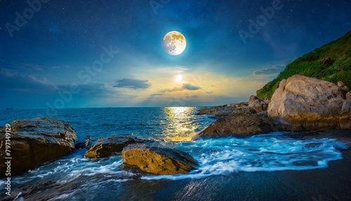 sea wave attacks the boulders of rocky shore with sun and moon at twilight day and night time change concept mysterious seascape scenery in morning light