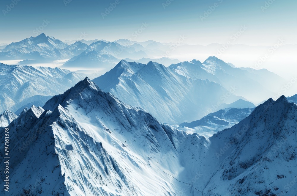 Majestic snow-covered mountain range under a clear blue sky