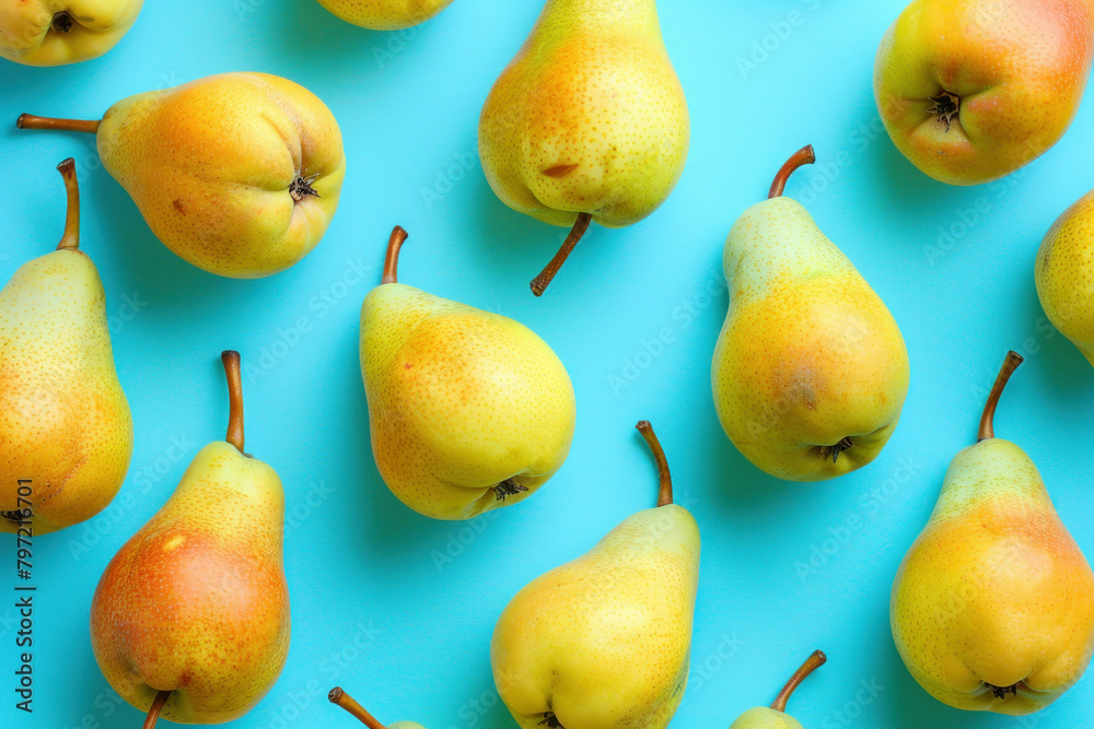 Assorted fresh pears on blue background, tops facing viewer, fruit arrangement for healthy eating concept Assorted fresh pears on blue background, tops facing viewer, fruit arrangement for healthy eating concept