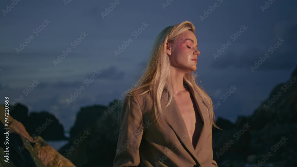 Woman silhouette evening beach at cloudy sky closeup. Flashing light on model Woman silhouette evening beach at cloudy sky closeup. Flashing light on model