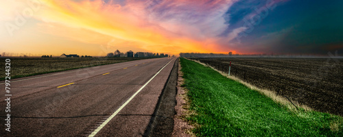South Dakota Stormy Sunset on the rural road and the agricultural field in Lincoln County, a beautiful landscape of the American Heartland of the Upper Midwest, USA