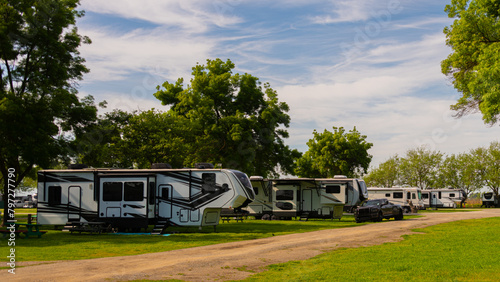 Large Rv trailers parked at campsite on grass