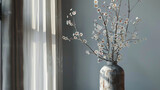 A tall, slender vase filled with elegant branches of cherry blossoms, symbolizing the beauty of nature.