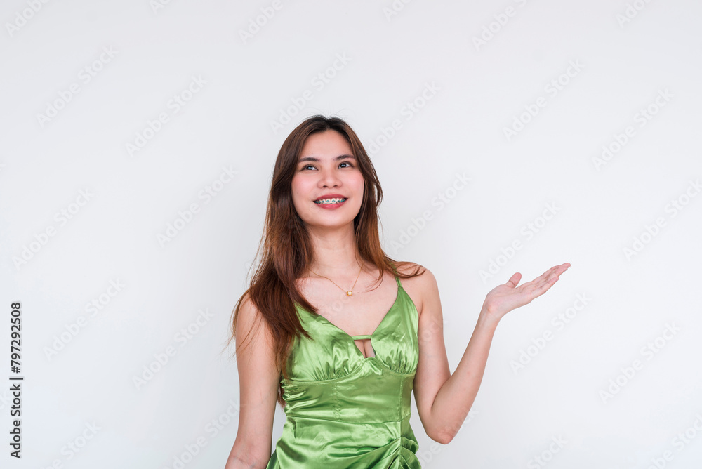 Elegant woman in light green silk dress presenting with hands, isolated on white Elegant woman in light green silk dress presenting with hands, isolated on white