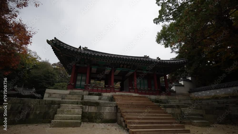 a traditional Korean pavilion with intricate roof designs at Changdeokgung Palace’s Secret Garden in Seoul, surrounded by autumn foliage and a serene environment. a traditional Korean pavilion with intricate roof designs at Changdeokgung Palace’s Secret Garden in Seoul, surrounded by autumn foliage and a serene environment.