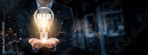 B2B: Innovation, Collaboration, Data Exchange concept. Hands of businessman holding light bulb and B2B with data network digital technology. Business-to-Business Solutions.