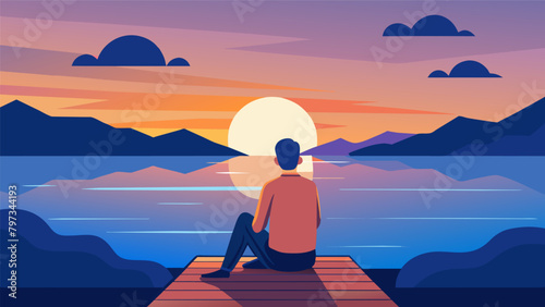 A man sits on a quiet dock his feet dangling in the water as he watches the sun dip below the horizon..