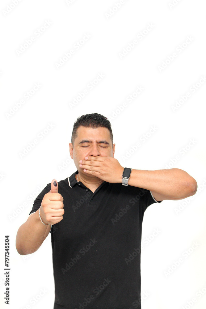 Dark-skinned Latino adult man shows his thumb inked with indelible electoral ink after marking his free and secret vote in the box Dark-skinned Latino adult man shows his thumb inked with indelible electoral ink after marking his free and secret vote in the box