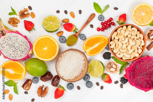 Assorted fresh fruits and nuts on a white background. Ingredients for a healthy dish