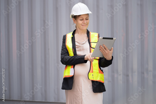 Portrait Happy caucasian logistic engineer pregnant woman  working at container site	