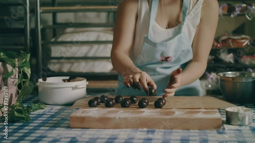 Baker rolling chocolate ball between her hands photo