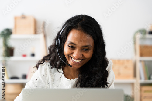Support service worker wearing headset. Indian smiling woman talking on a video call.