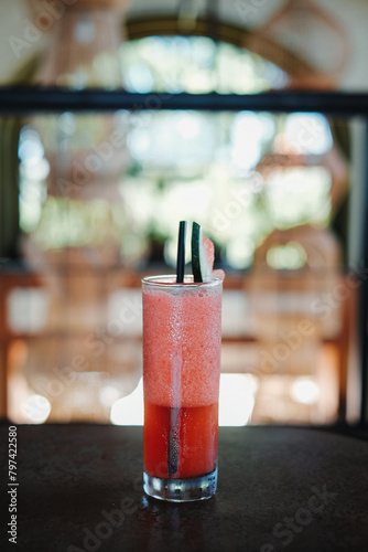 Strawberry cocktail in a tall glass with bokeh background