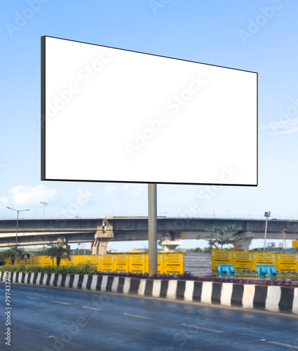Billboard mockup outdoors. An empty roadside outdoor against blue sky background for presentation, blank commercial mock-up, ooh, poster, banner, hoarding, dummy placement for ads, branding