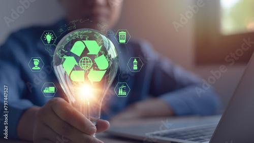 LCA life cycle assessment concept and environmental impact assessments related to product value chains. Businessman holds a light bulb with a globe and LCA icon on a virtual screen. photo