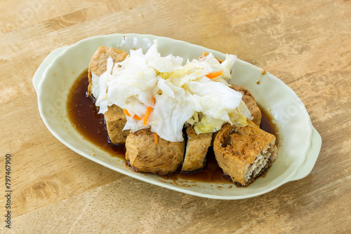 Close-up of delicious stinky tofu. it is a street snack commonly found at night markets or roadside stalls in Taiwan, popular with tourists. 